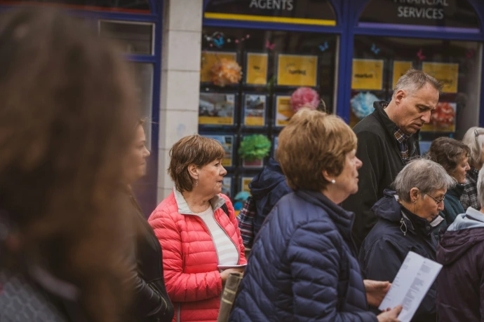 Customers waiting in a long line at the billing counter